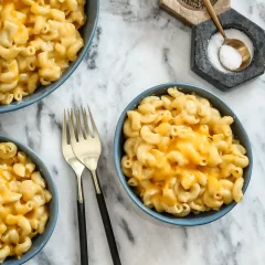 Golden baked macaroni and cheese in blue bowls.