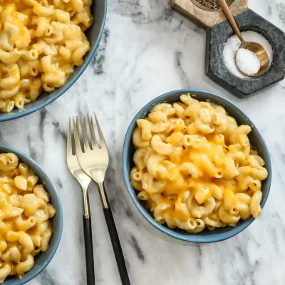 Golden baked macaroni and cheese in blue bowls.