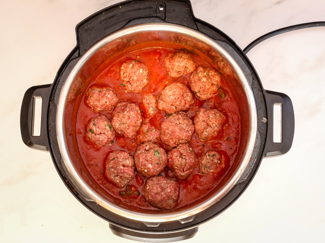 Instant Pot with meatballs and tomato sauce.