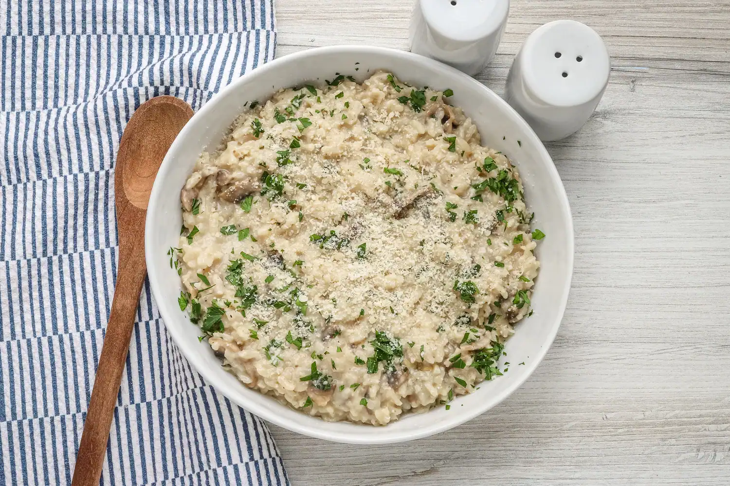 Creamy mushroom risotto garnished with parsley.