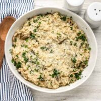 Creamy mushroom risotto with grated cheese and chopped herbs.
