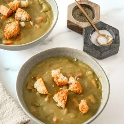 Creamy green vegetable soup topped with croutons and grated cheese.