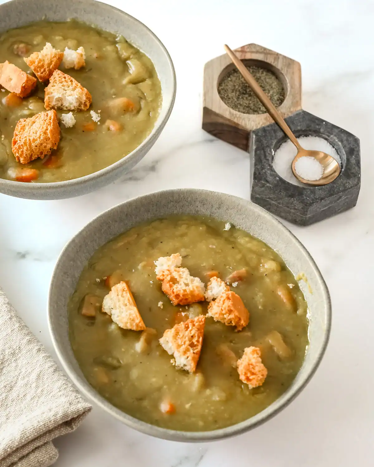 Creamy green vegetable soup topped with croutons and grated cheese.