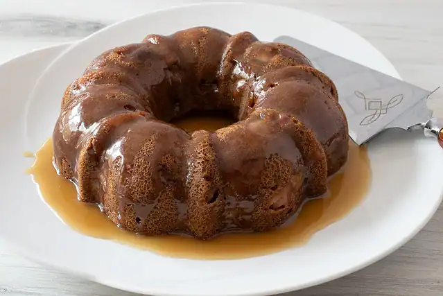 Instant Pot pear cake on a platter, ready to slice and enjoy.