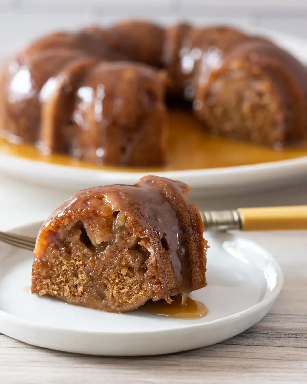 Rich caramel apple bread pudding drizzled with caramel sauce.