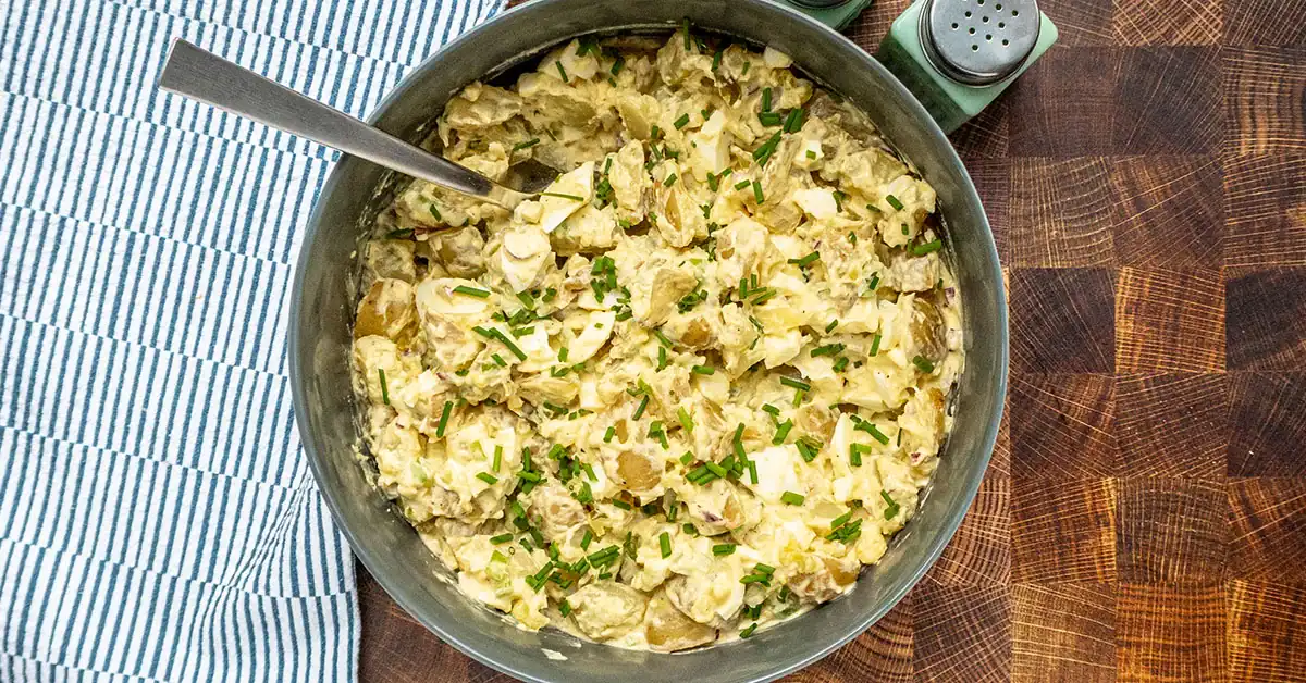 A serving bowl with potato salad.