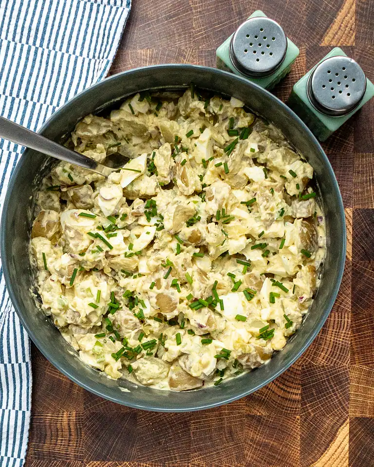 Creamy potato salad with chopped chives.