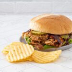 instant pot pulled chicken sandwich with chips and barbecue sauce