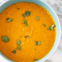 A bowl of Instant Pot red lentil dal with cilantro garnish.
