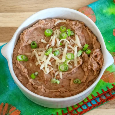 Creamy mashed potatoes topped with shredded cheese and chopped green onions.