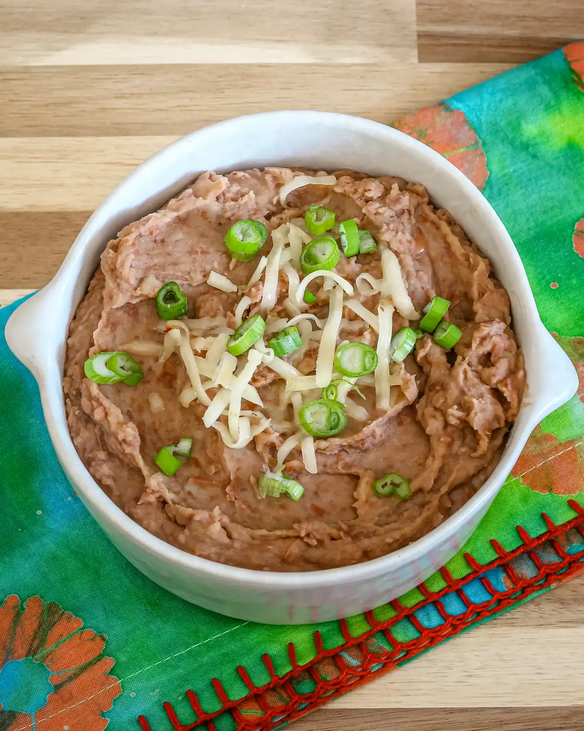 Creamy mashed potatoes topped with shredded cheese and chopped green onions.