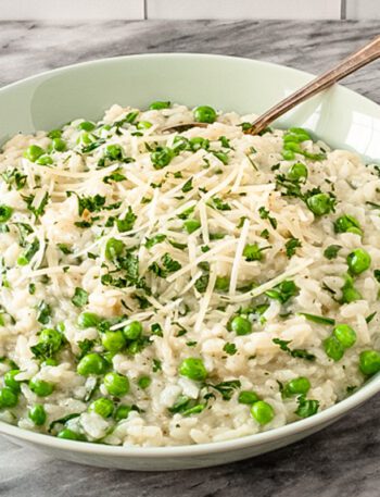 a serving dish with risotto and parmesan cheese