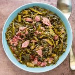 bowl of southern greens with shredded ham hock