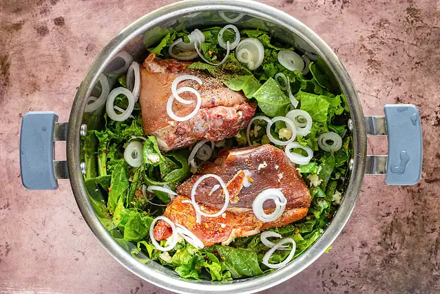 Greens, ham hocks, and seasonings in the Instant Pot.