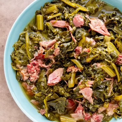 Boiled greens with pieces of ham in a light broth.