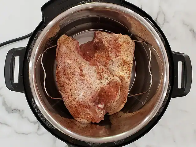 Split chicken breasts in the Instant Pot, ready to pressure cook.