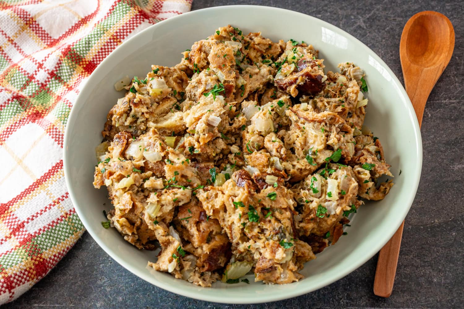 Instant Pot stuffing in a serving bowl with a spoon beside it.