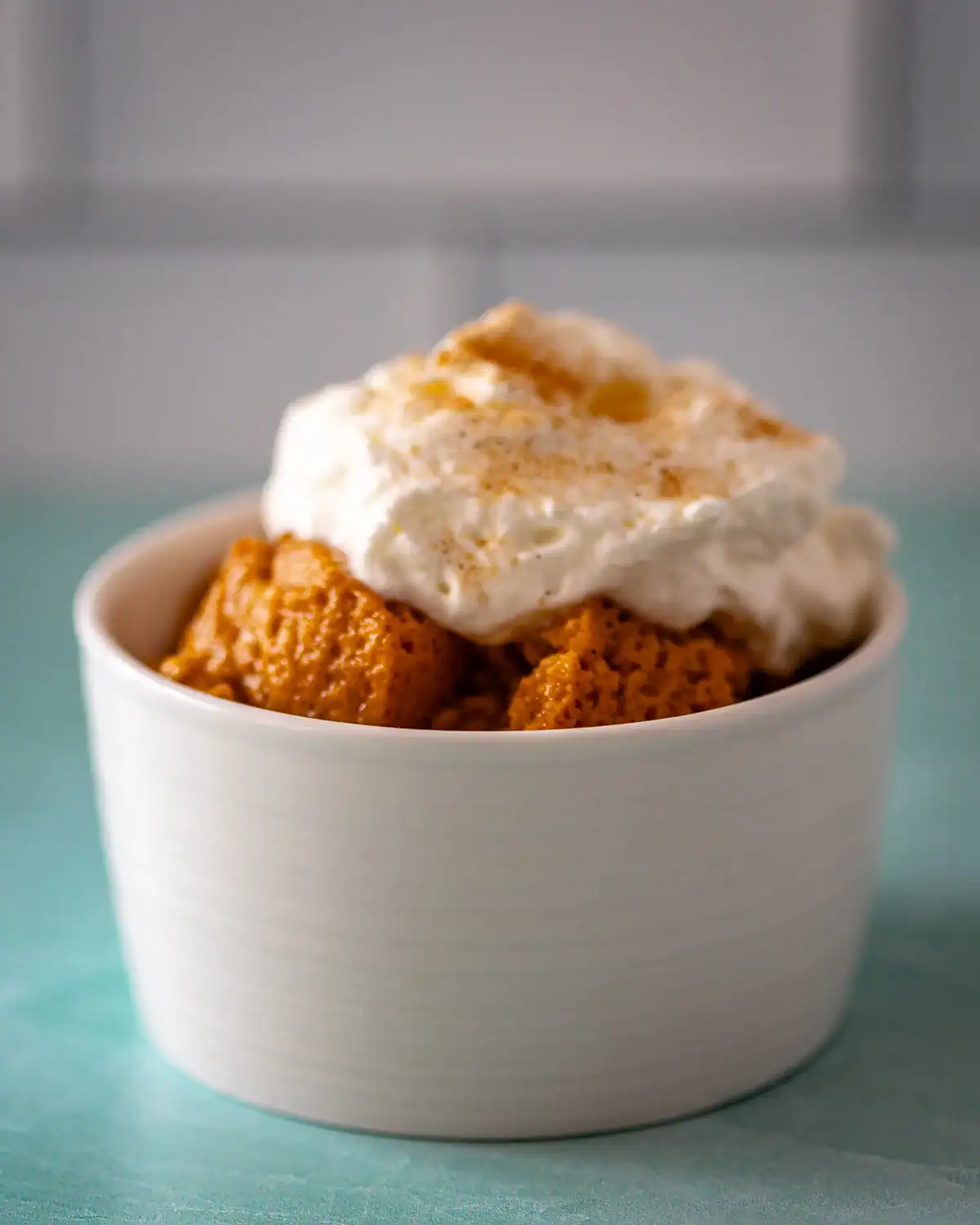 Sweet potato casserole topped with whipped cream and cinnamon.