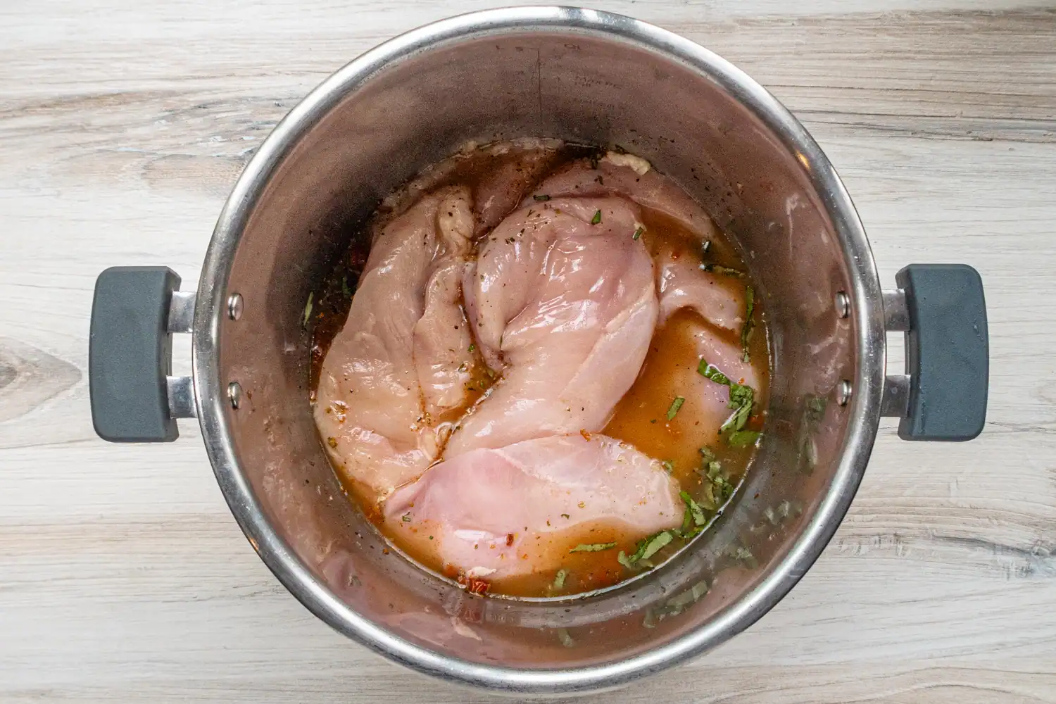Tuscan chicken prep: chicken added to the Instant Pot.