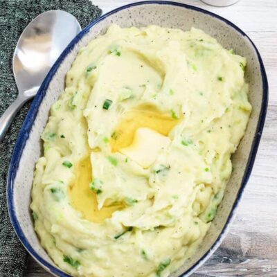 Creamy mashed potatoes with a butter well in the center.