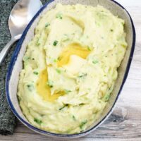 Creamy mashed potatoes with a butter well center.