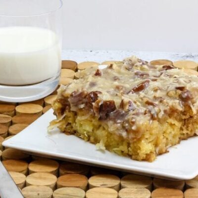 a slice of Cajun cake on a plate with a glass of milk