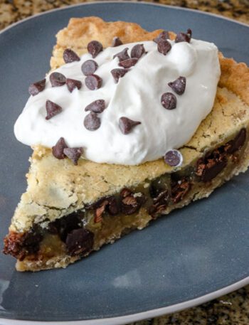 kentucky derby pie with chocolate cips and a whipped cream topping