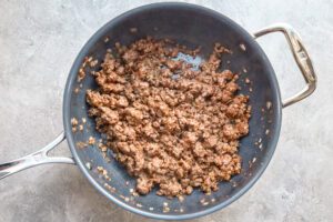 Keema matar prep, ground beef and seasonings in the pan.