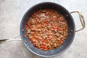 Keema matar prep with tomatoes and ground beef.