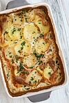 Baked dauphinoise potatoes with parsley garnish - potato gratin.