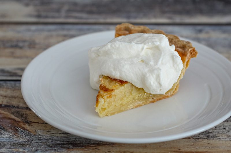 a lemon buttermilk pie with whipped cream