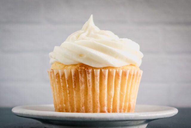 lemon cream cheese frosting on a lemon cupcake