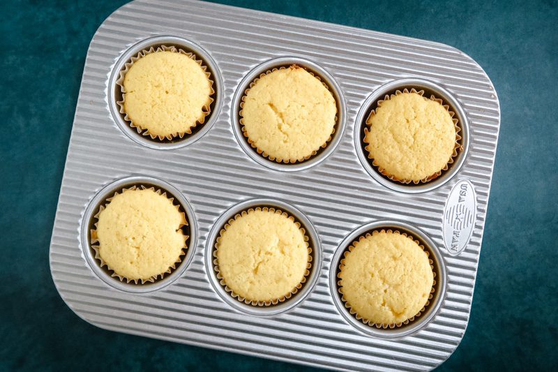 baked lemon cupcakes in a muffin tin