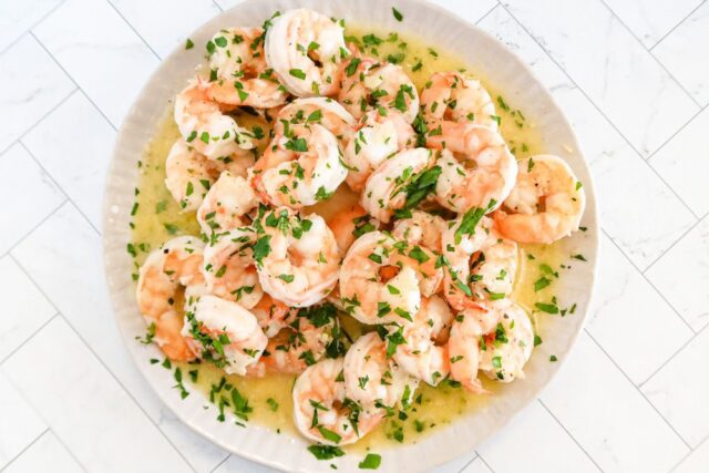 Shrimp in a bowl garnished with parsley.