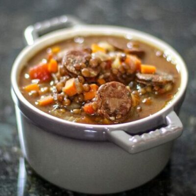 lentil and sausage soup in a small bowl