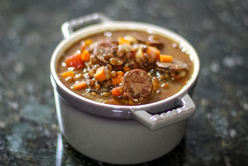 lentil and sausage soup in a small bowl