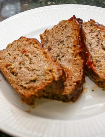 meatloaf with zucchini shown on a large plate