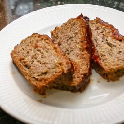 meatloaf with zucchini shown on a large plate