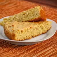 Homemade banana bread slices on a white oval plate.