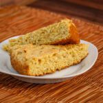 light onion cornbread wedges on a plate