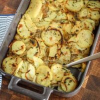 Golden roasted potato casserole with caramelized onions and herbs.