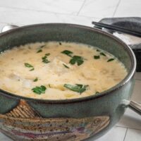 A big bowl of Maine haddock chowder garnished with parsley.