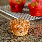 Freshly baked crumb-topped muffin with chocolate chips for breakfast or snack.