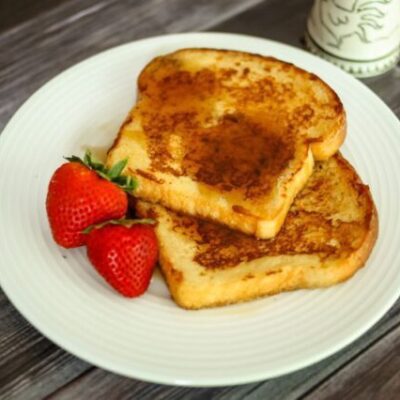 maple cinnamon french toast on a plate with strawberries