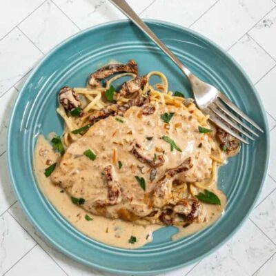Marry me chicken served on cooked spaghetti with creamy sundried tomato sauce.