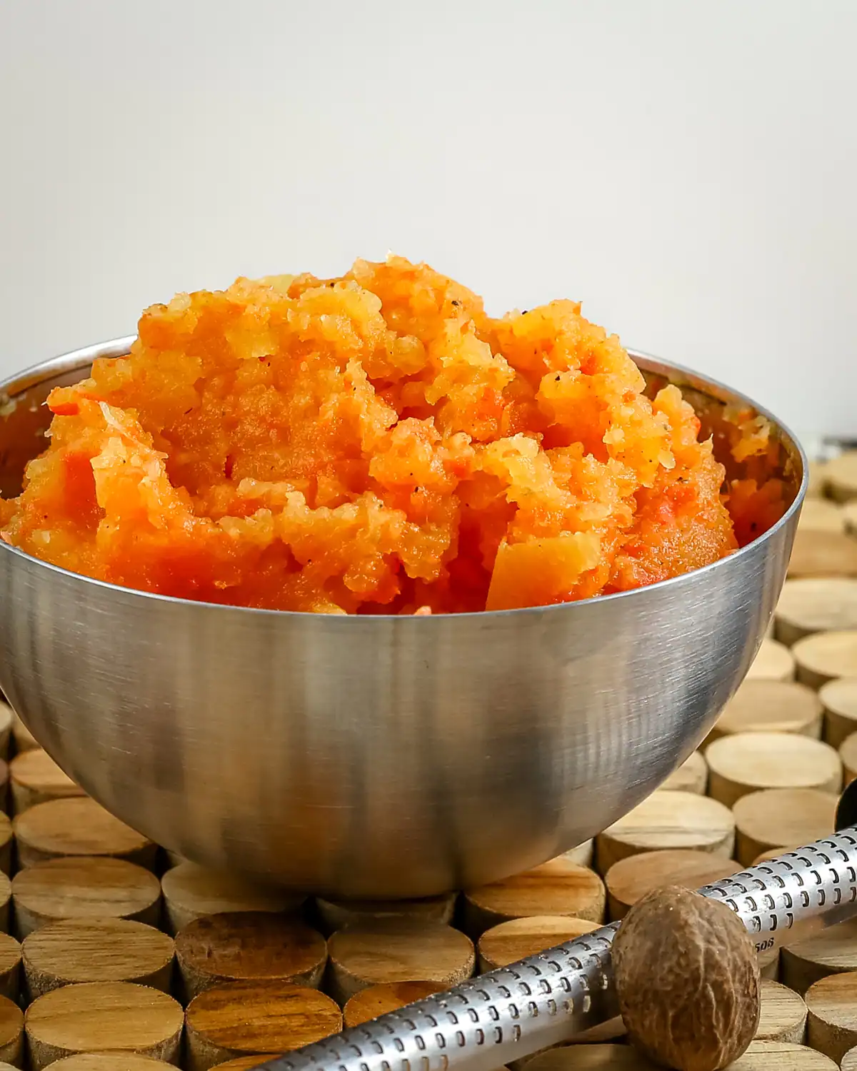 Creamy mashed sweet potatoes served in a metal bowl.