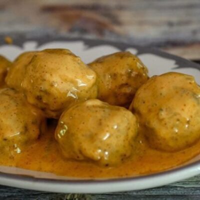 spicy tex-mex meatballs with cheese sauce on a plate