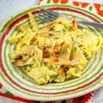 Mexican scrambled eggs with corn tortillas on a plate, also known as Migas.