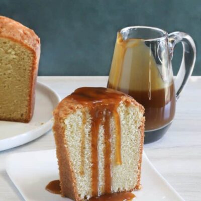 A slice of million dollar pound cake, a buttermilk pound cake with a caramel sauce drizzle.