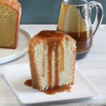A slice of million dollar pound cake, a buttermilk pound cake with a caramel sauce drizzle.